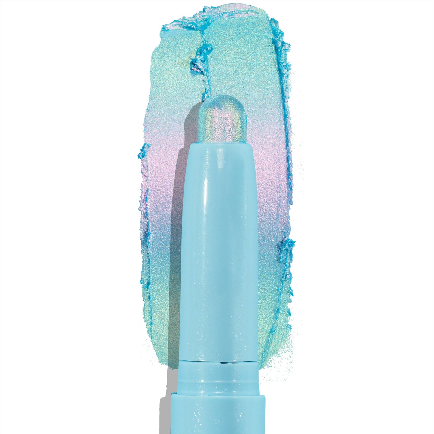 Colourpop Game Over Shadow Stix eye crayon gliding across a white background, leaving a bold metallic aqua, lavender, and mint duochrome shimmer swatch behind its pastel blue twist-up tube packaging.