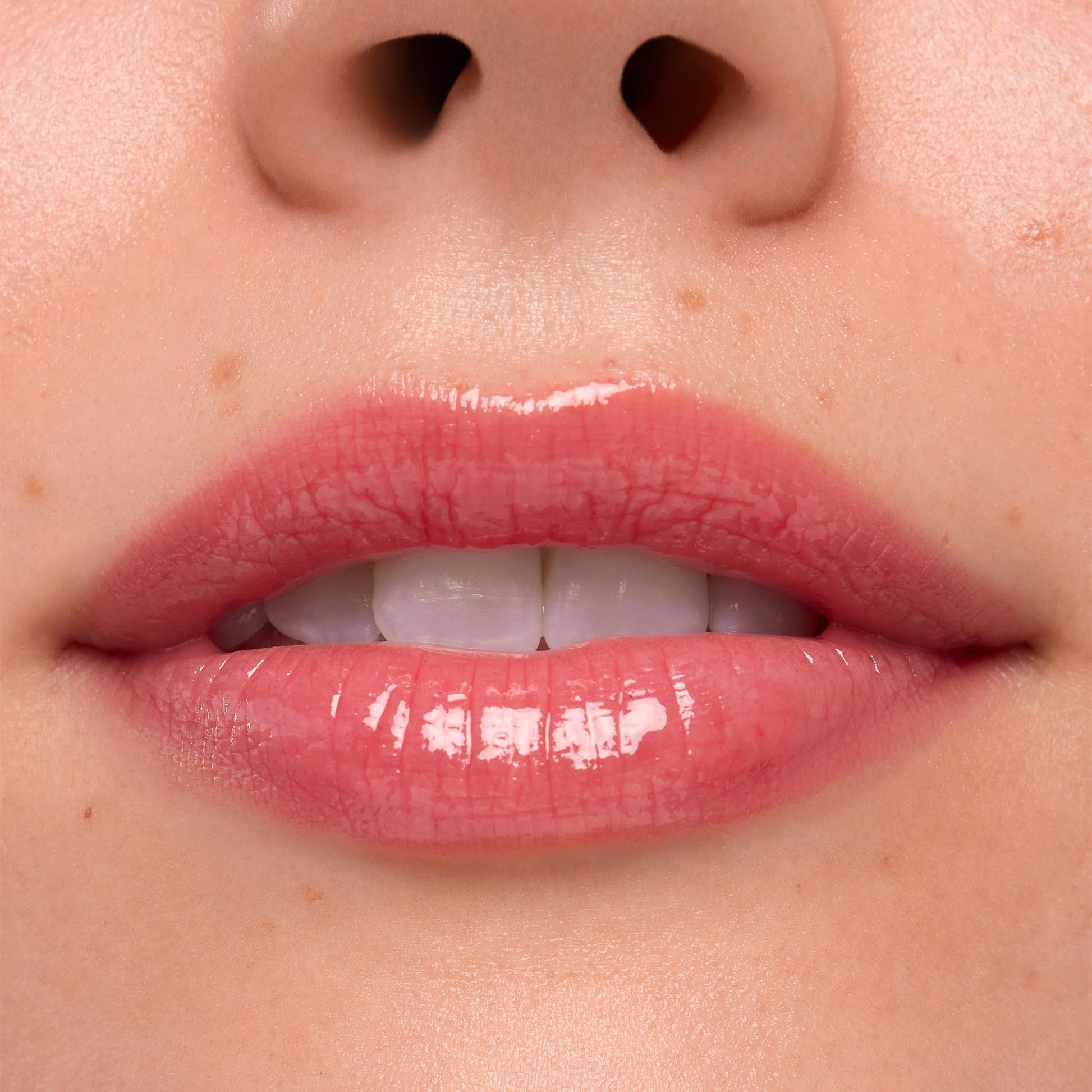 Lips wearing Experiment 626, the ColourPop Ultra Glossy Lip, gleaming with a high-shine sheer rosy pink finish in a tight close-up studio swatch, emphasizing smooth texture and natural lip lines.